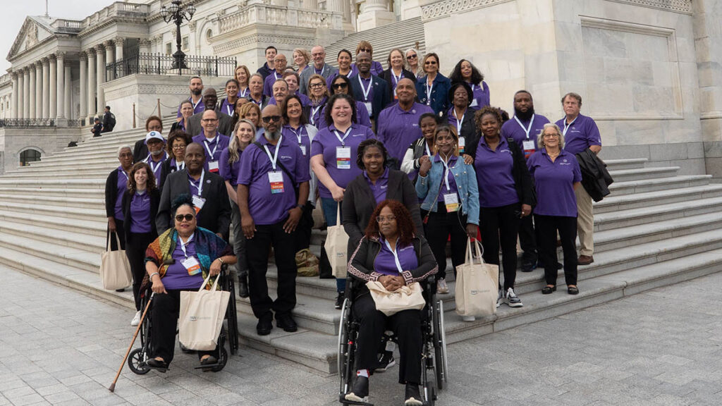 Large group of PAN volunteers, staff, and advocates gathered at steps of the capitol building