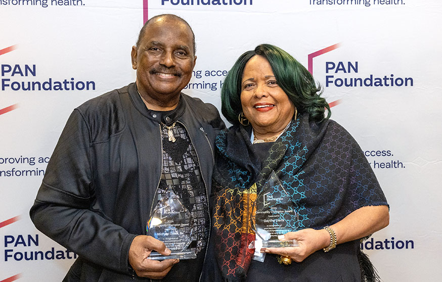 Michael and Gaytha standing together holding their awards